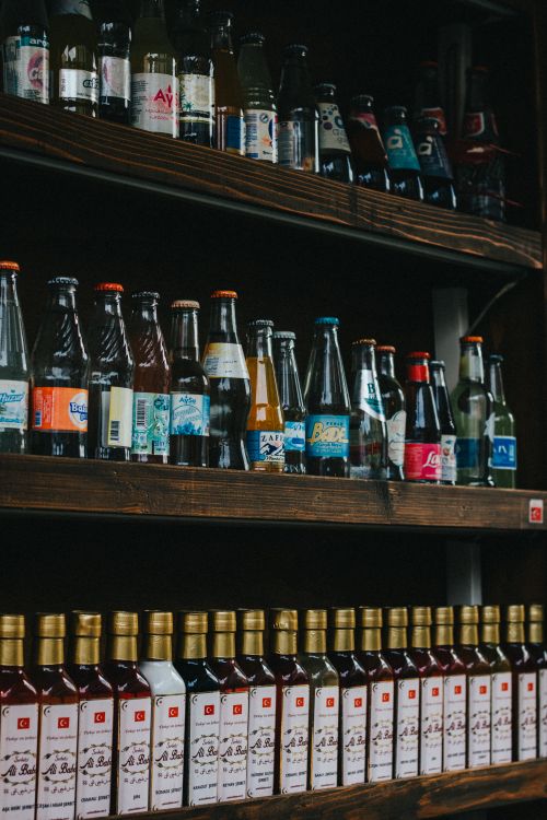 Free A vibrant assortment of drinks on wooden shelves in a pub, showcasing various bottles in Istanbul. Stock Photo