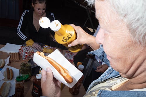 Woman Preparing Hot Dog