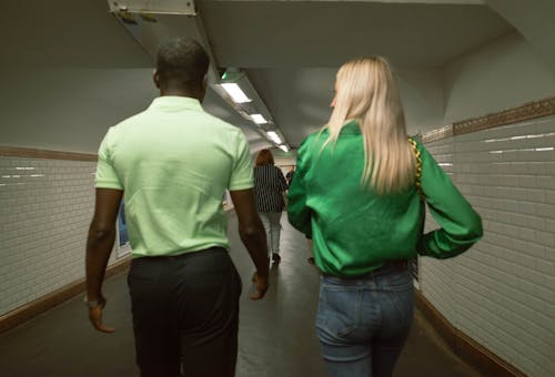 Woman and Man in Green Clothes on Corridor