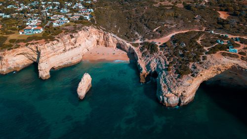 Free Drone shot of the stunning cliffs and ocean at Carvalho Beach, Algarve, Portugal. Stock Photo