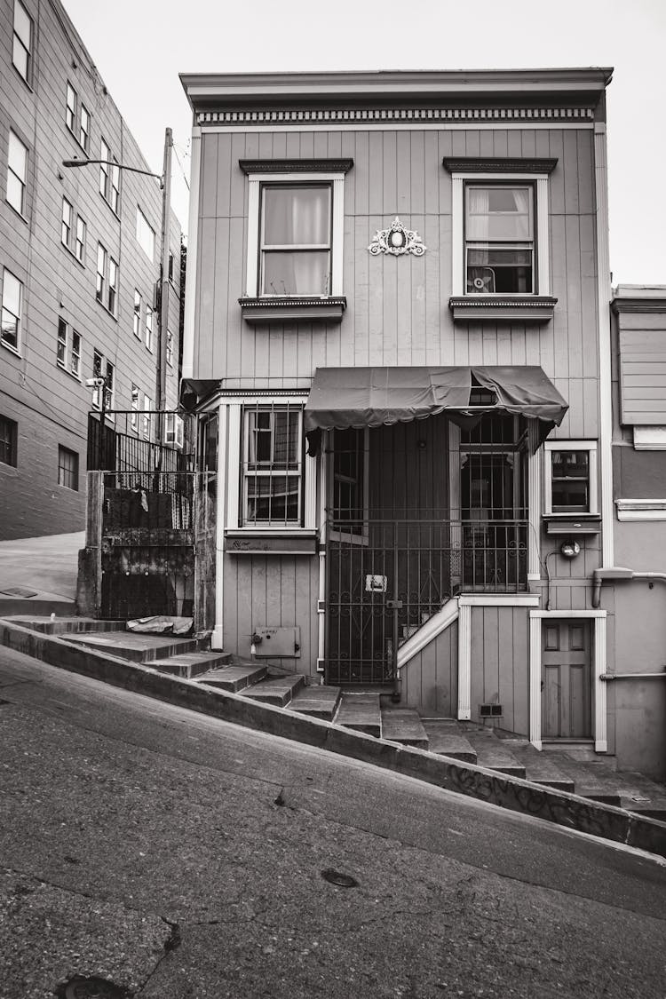 Black And White Photo Of An Old House On A Steep Hilly Street, San Francisco, USA