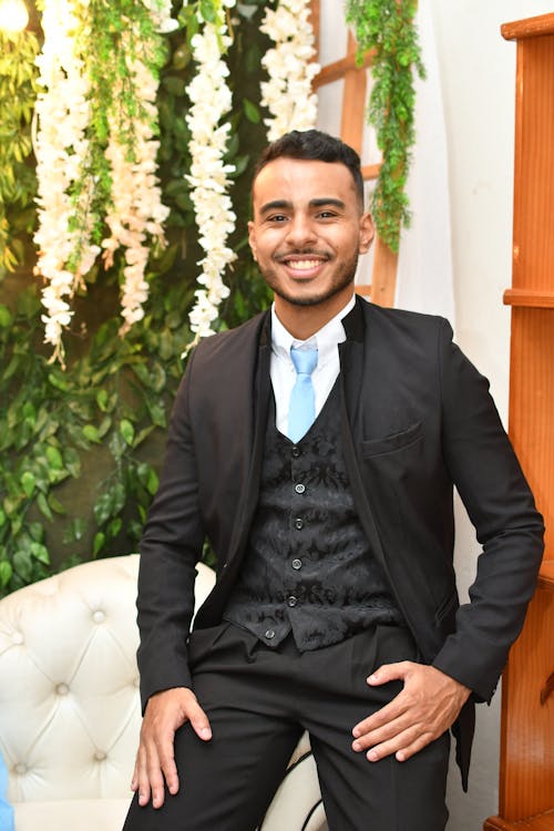 Elegant Young Man in a Suit Sitting and Smiling