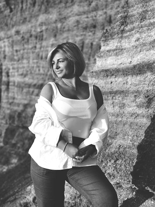 Young Woman Posing in front of Rock Formation 