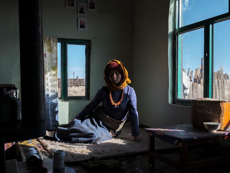 Woman In Hijab Sitting On Bed