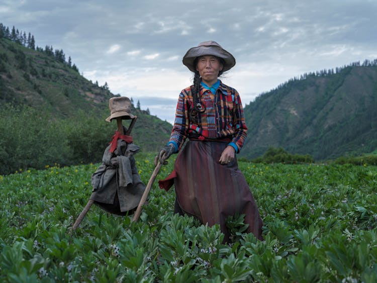 Woman And Scarecrow On Field