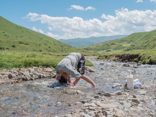 Man Washing Hair in Stream