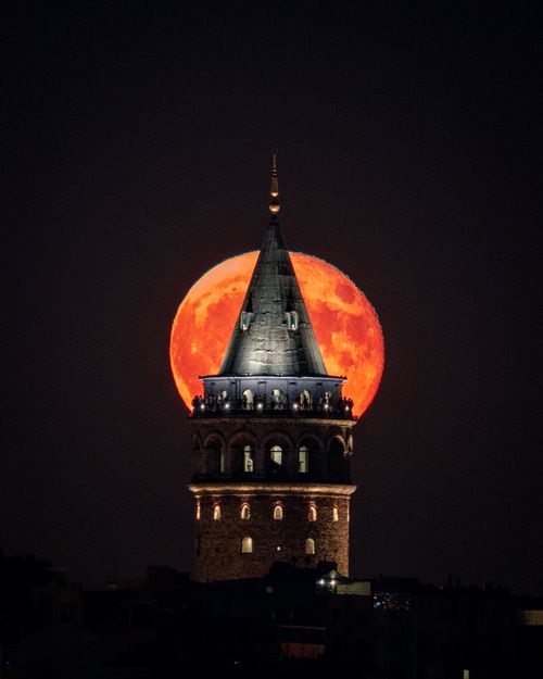 Free Stunning image of Istanbul's Galata Tower with a red full moon at night. Stock Photo