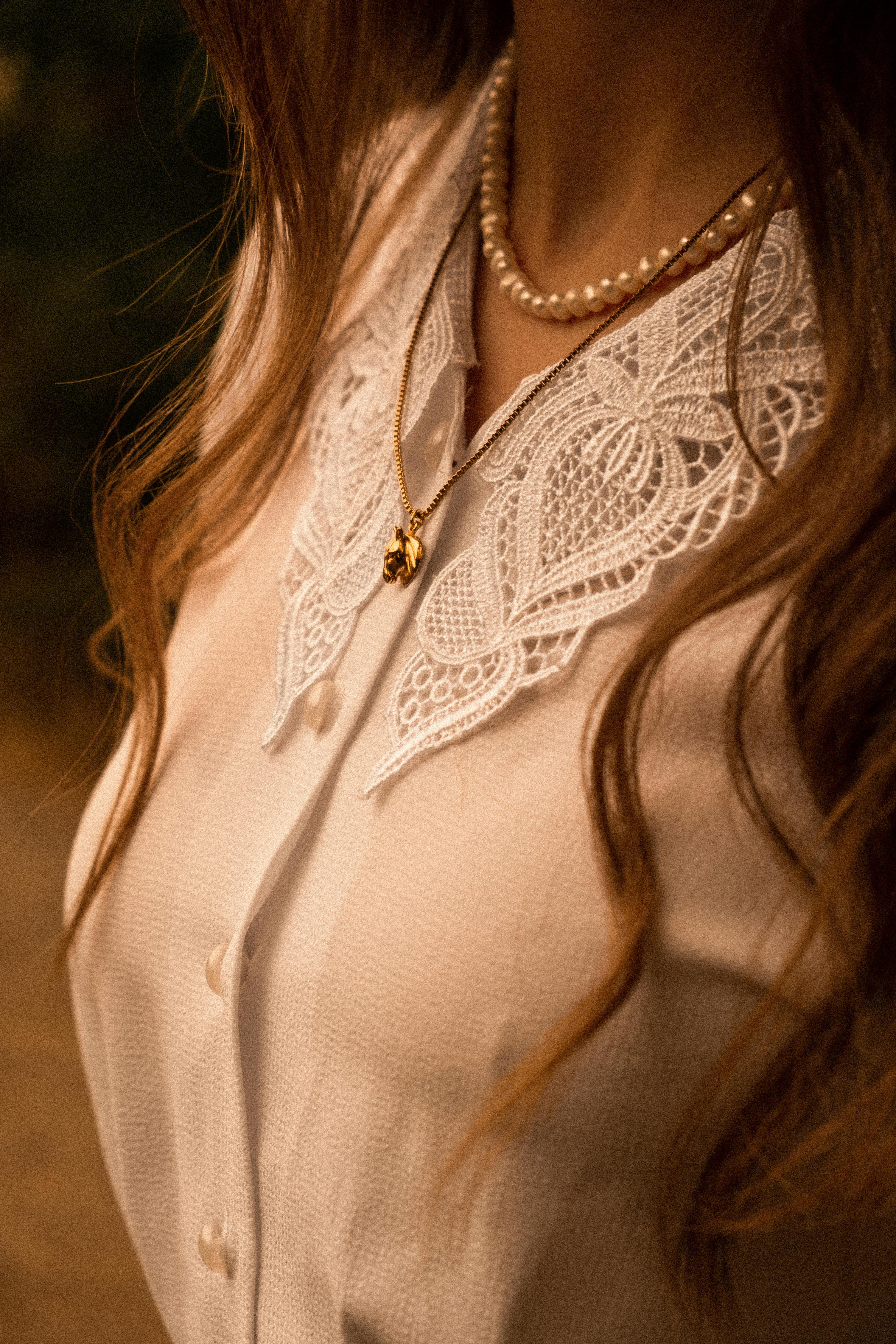 Pearl-collared lace blouse showing delicate cutwork pattern