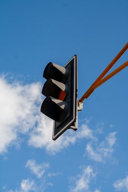 Free A vertical shot of a traffic light with a blue sky background in Mérida, Venezuela. Stock Photo