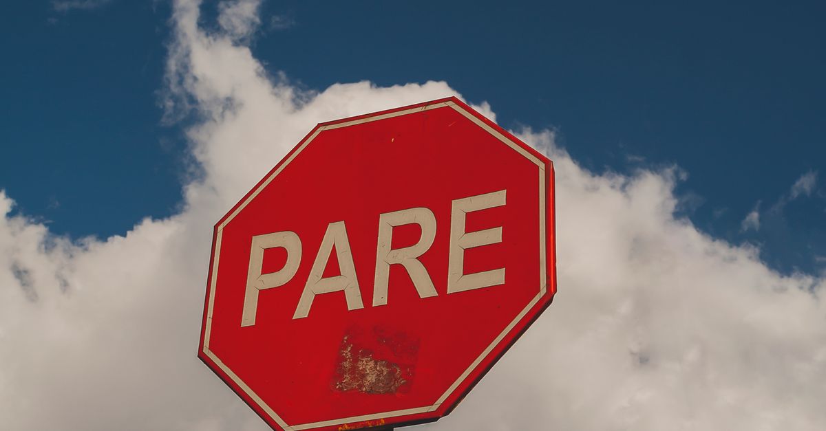 Stop Sign In Peru Peruvian Stop Sign on a Yellow Pole · Free Stock Photo