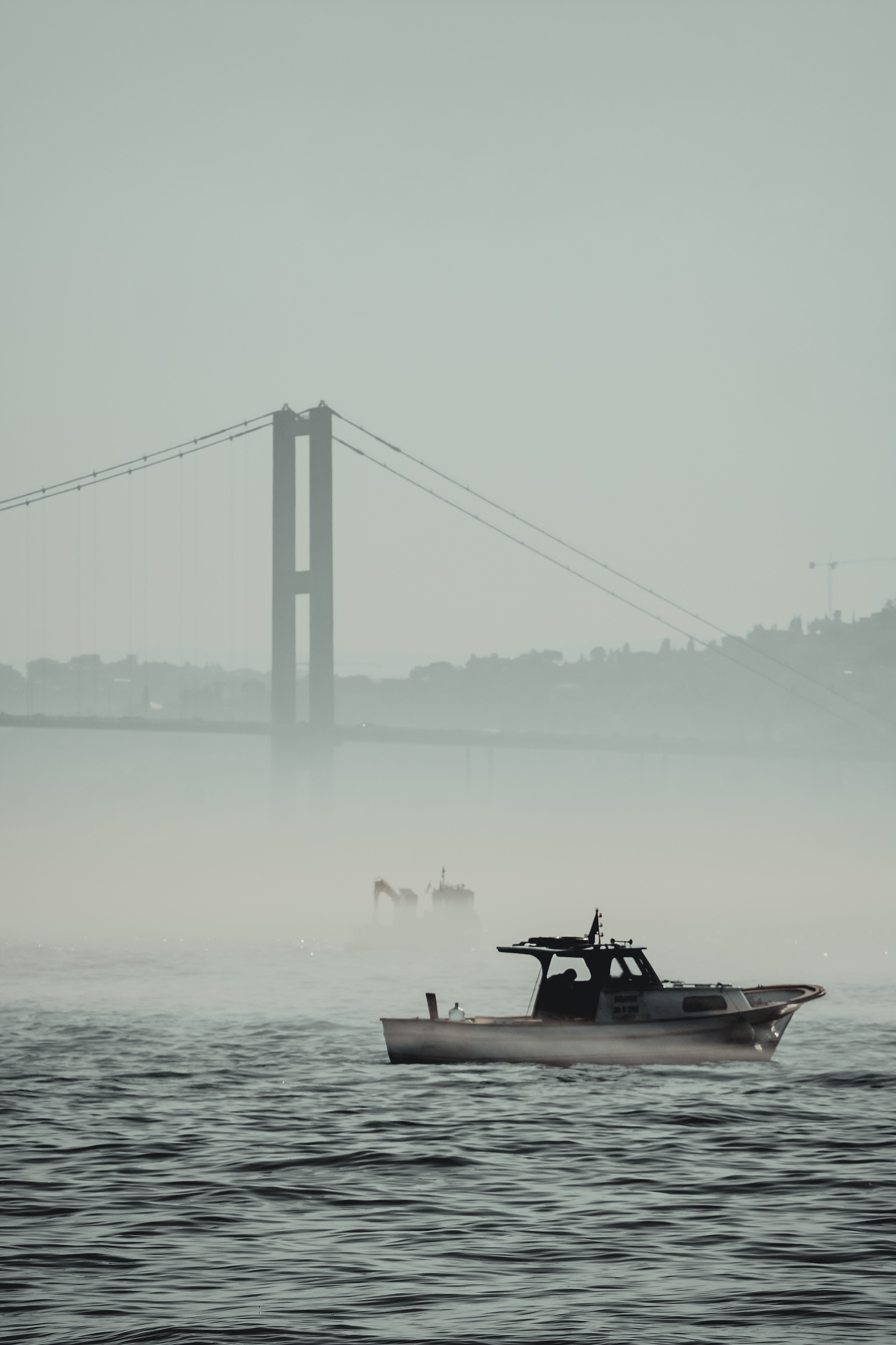 Motorboat on Sea against Bosphorus Bridge in Istanbul · Free Stock Photo