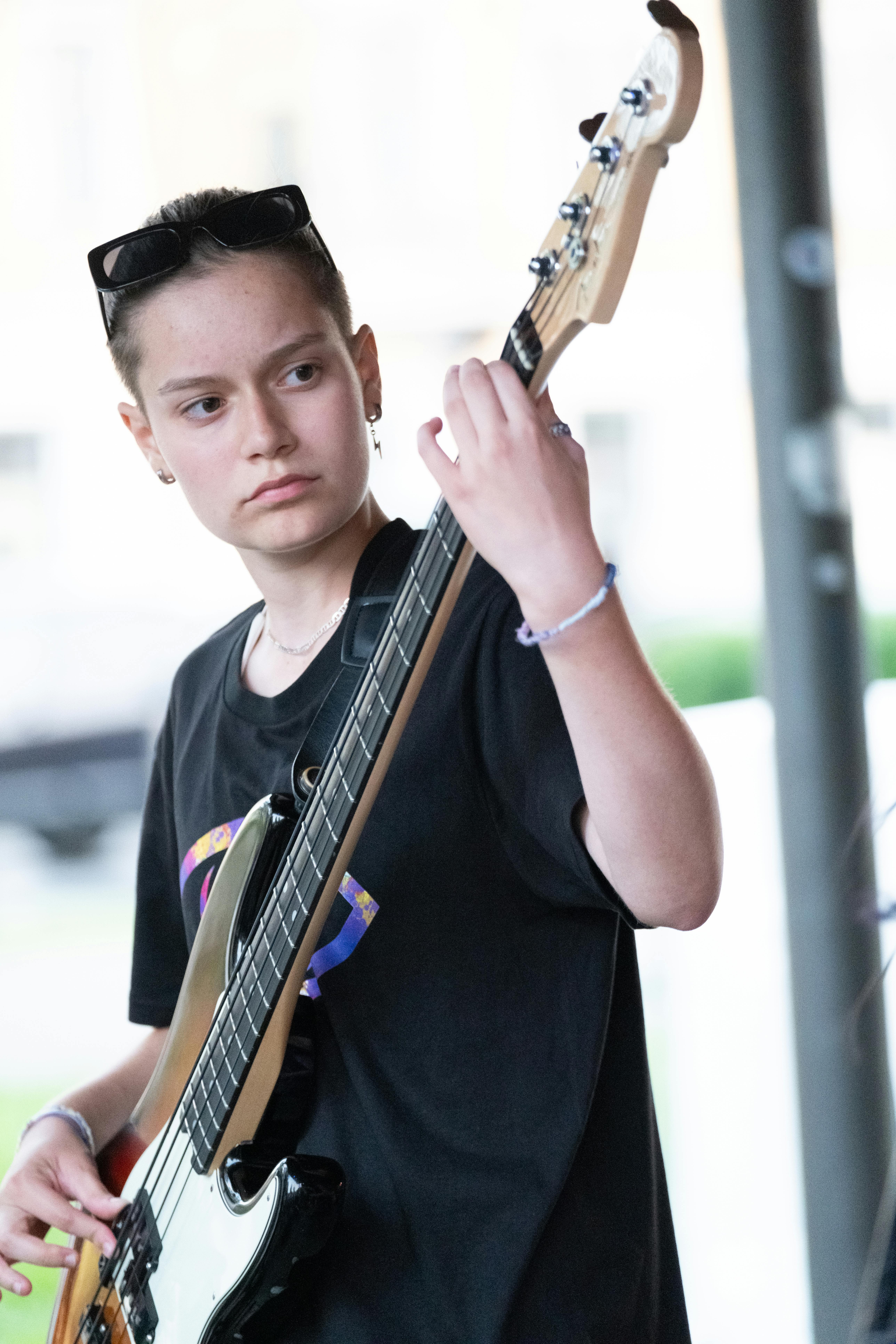 A Man in Black Leather Jacket Playing a Bass Guitar · Free Stock Photo