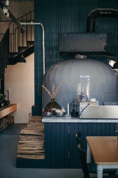 A cozy modern kitchen in Ankara featuring a large pizza oven and rustic decor.
