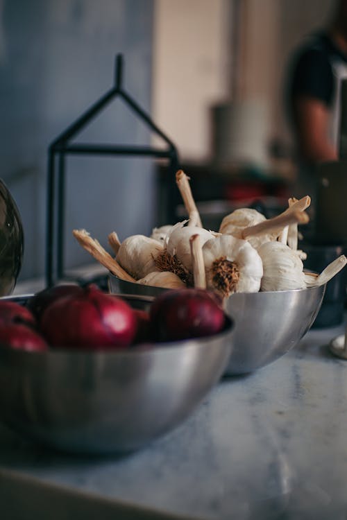 Free Onions and Garlic in Metal Bowls Stock Photo