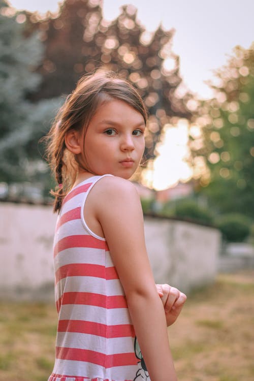 Girl in Striped Tank Top Looking over Shoulder