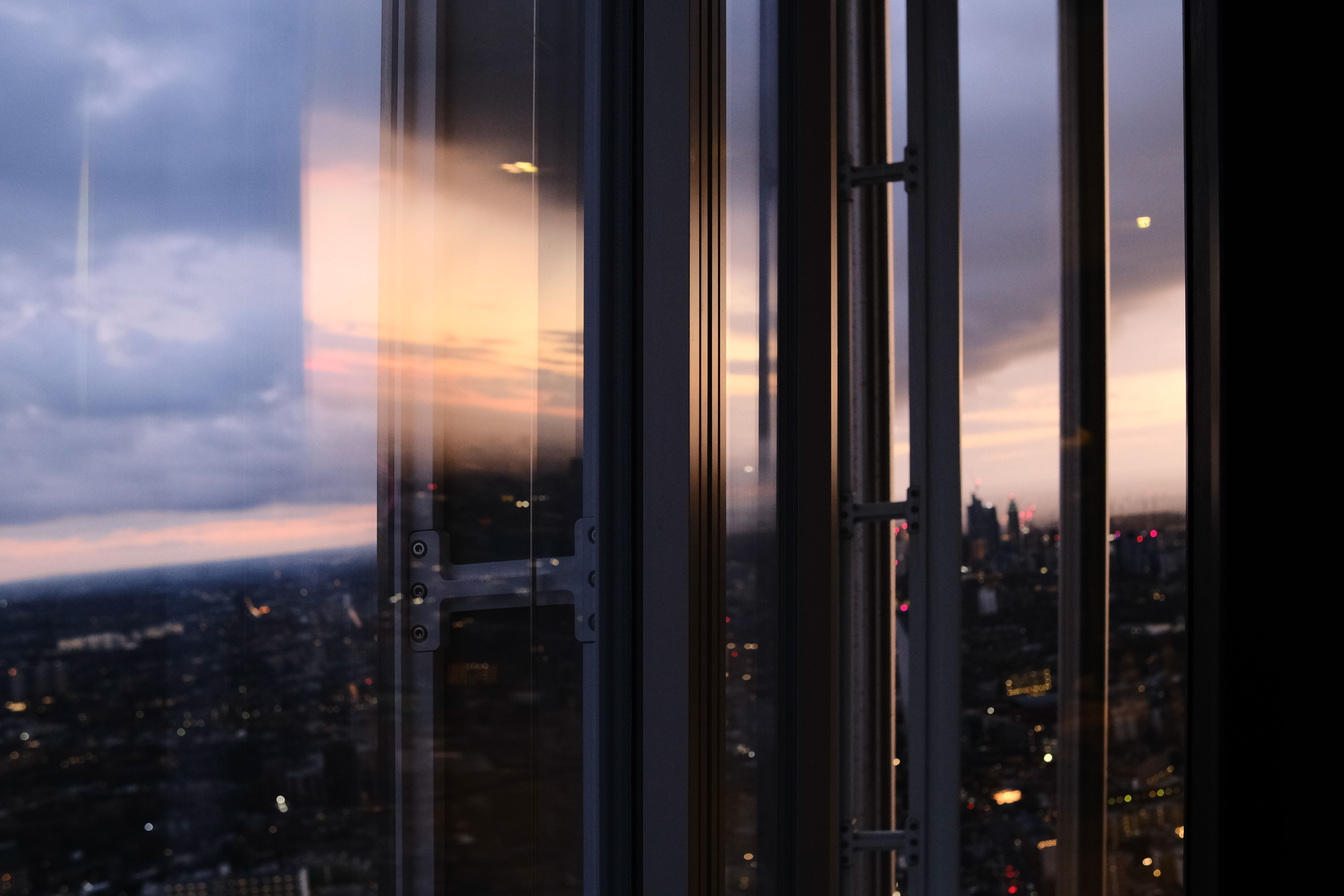 A minimalist luxury private study overlooking the London skyline at twilight, representing mental clarity and cognitive sanctuary.