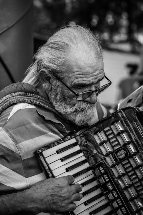 Black and White Picture of an Elderly Man Playing the Accordion