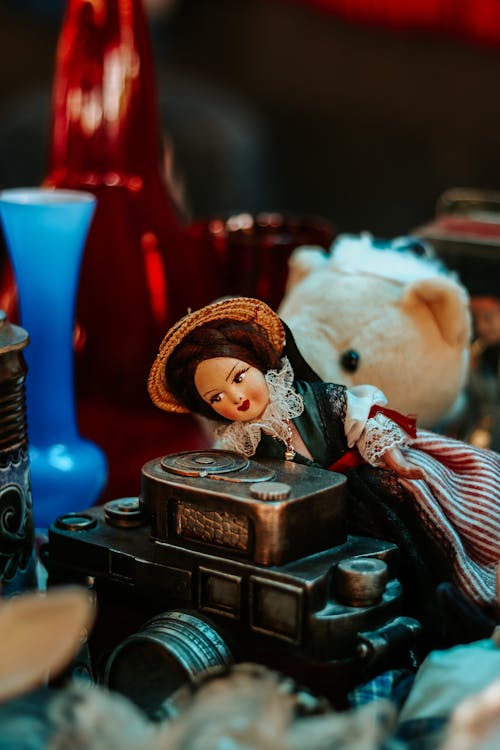 Doll Lying on a Camera Figurine