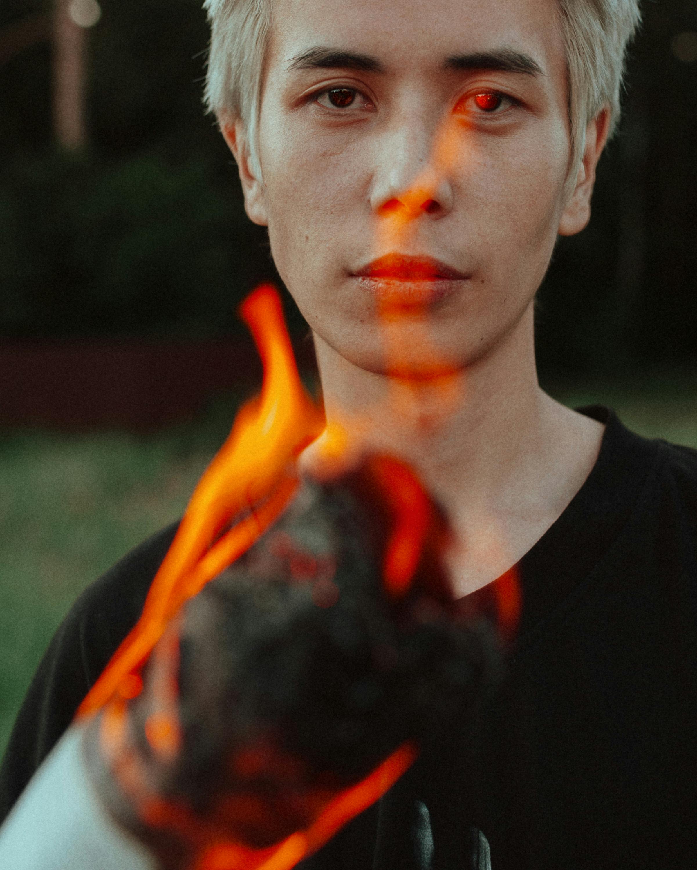 Man burning sheets of paper free stock photo