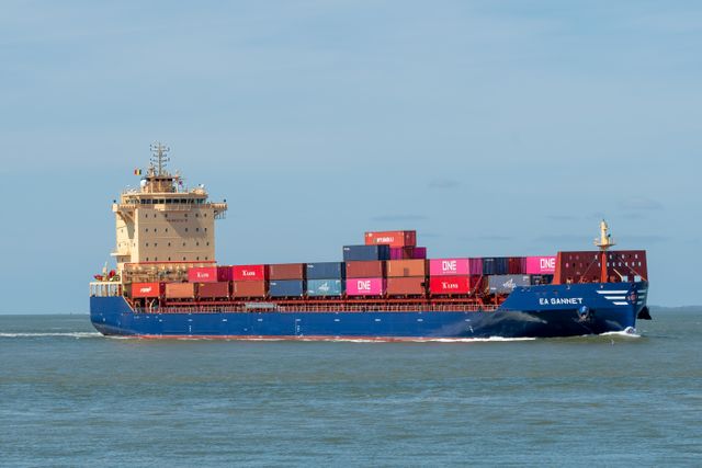 Cargo ship transporting colorful containers on a clear day
