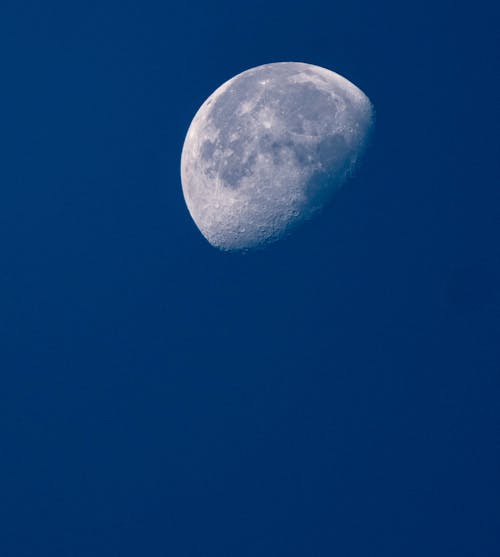 A Quarter Moon against Blue Sky 