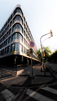 A modern building with sleek geometric architecture in an urban city setting.