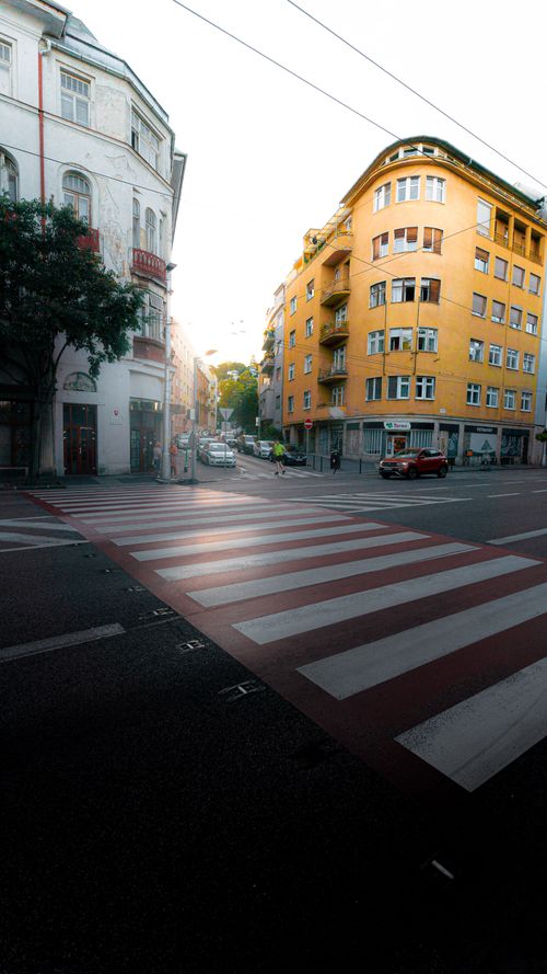 Free City street corner with buildings and zebra crossing at dawn. Stock Photo