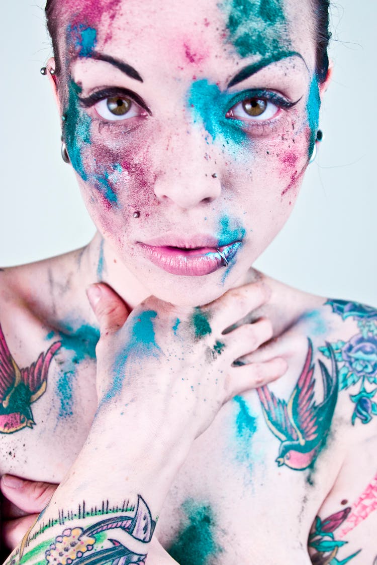 Model With Colorful Abstract Makeup And Tattoos