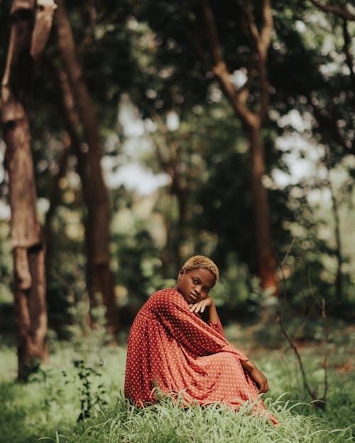 Woman in Red Spotted Dress Sitting in Forest