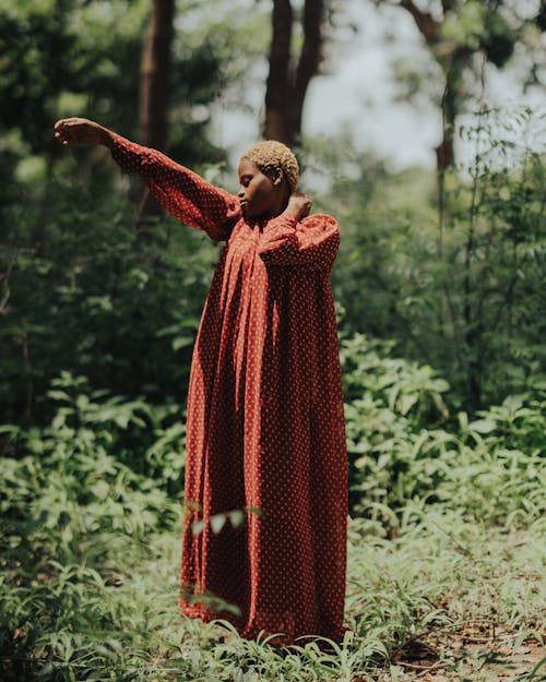 Woman in Red Dress Posing in Forest