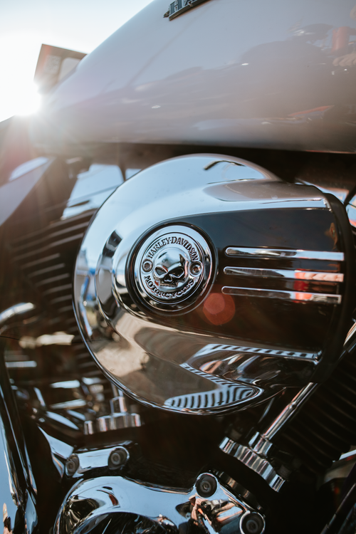 Free Detailed shot of a chrome Harley Davidson motorcycle engine with sunlit reflections. Stock Photo
