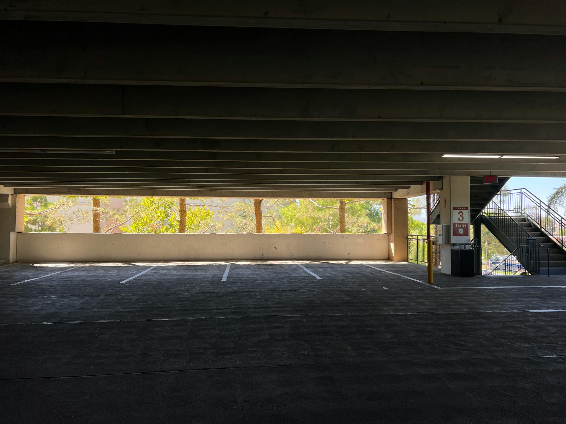 Explore an empty level of a multistory parking garage in Santa Clarita under natural daylight.