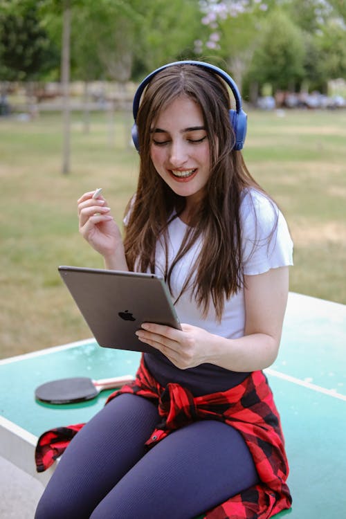 A girl with headphones and a tablet