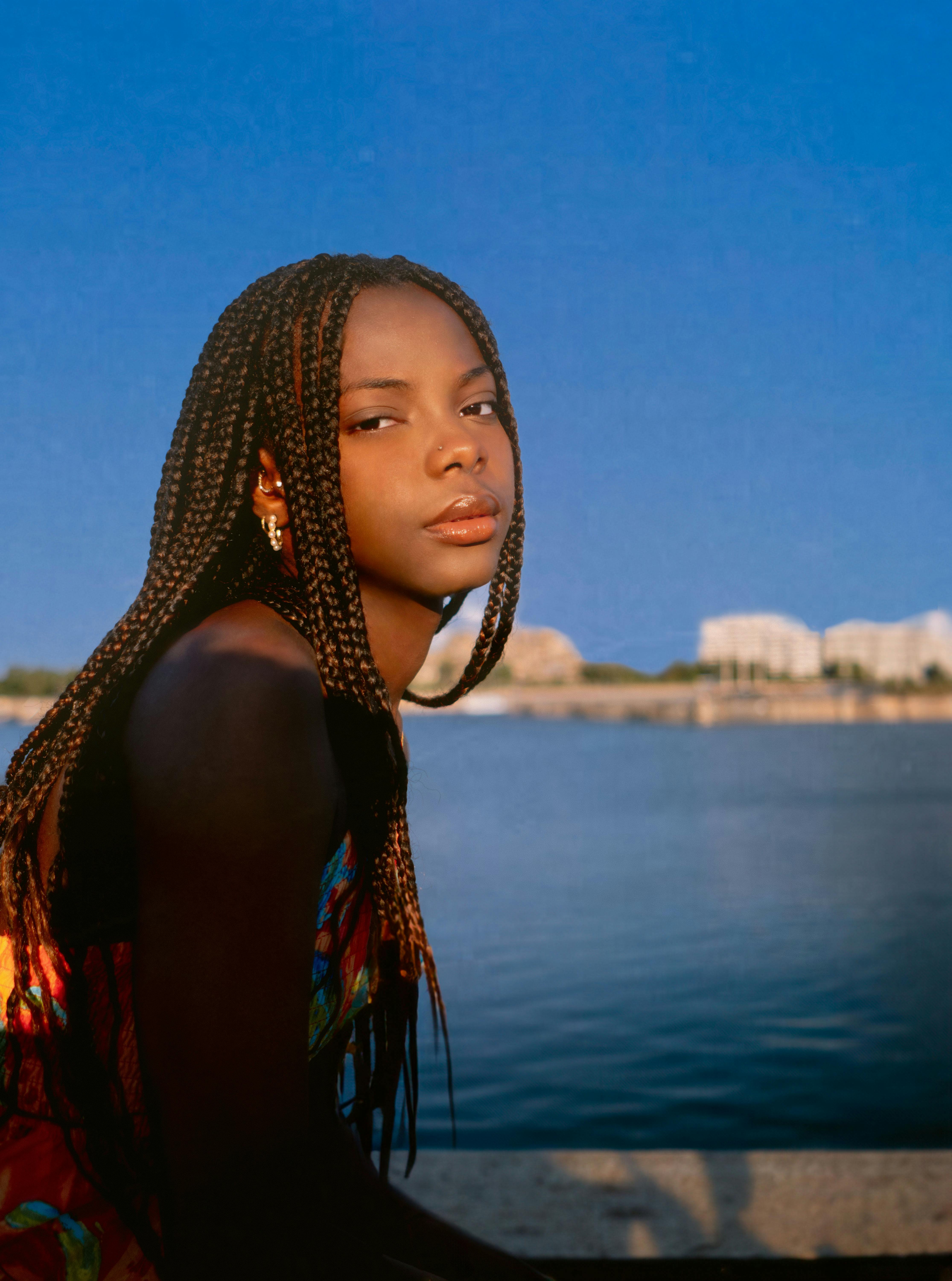 Elegant portrait of a woman with braided hair by the water in Montreal.