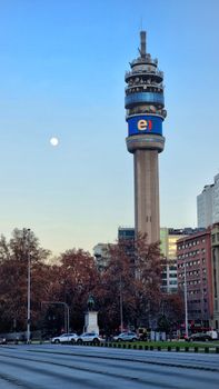 The Entel Tower in Santiago, Chile stands tall under a clear sky, showcasing modern urban architecture.
