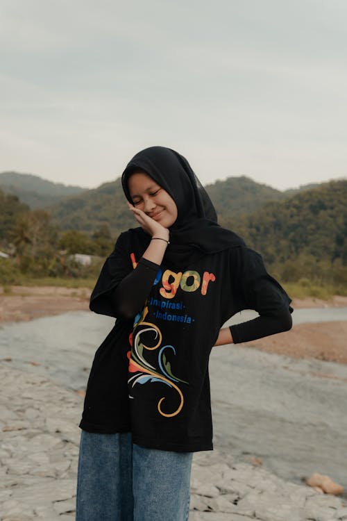 Woman in Hijab Standing with Hand on Cheek