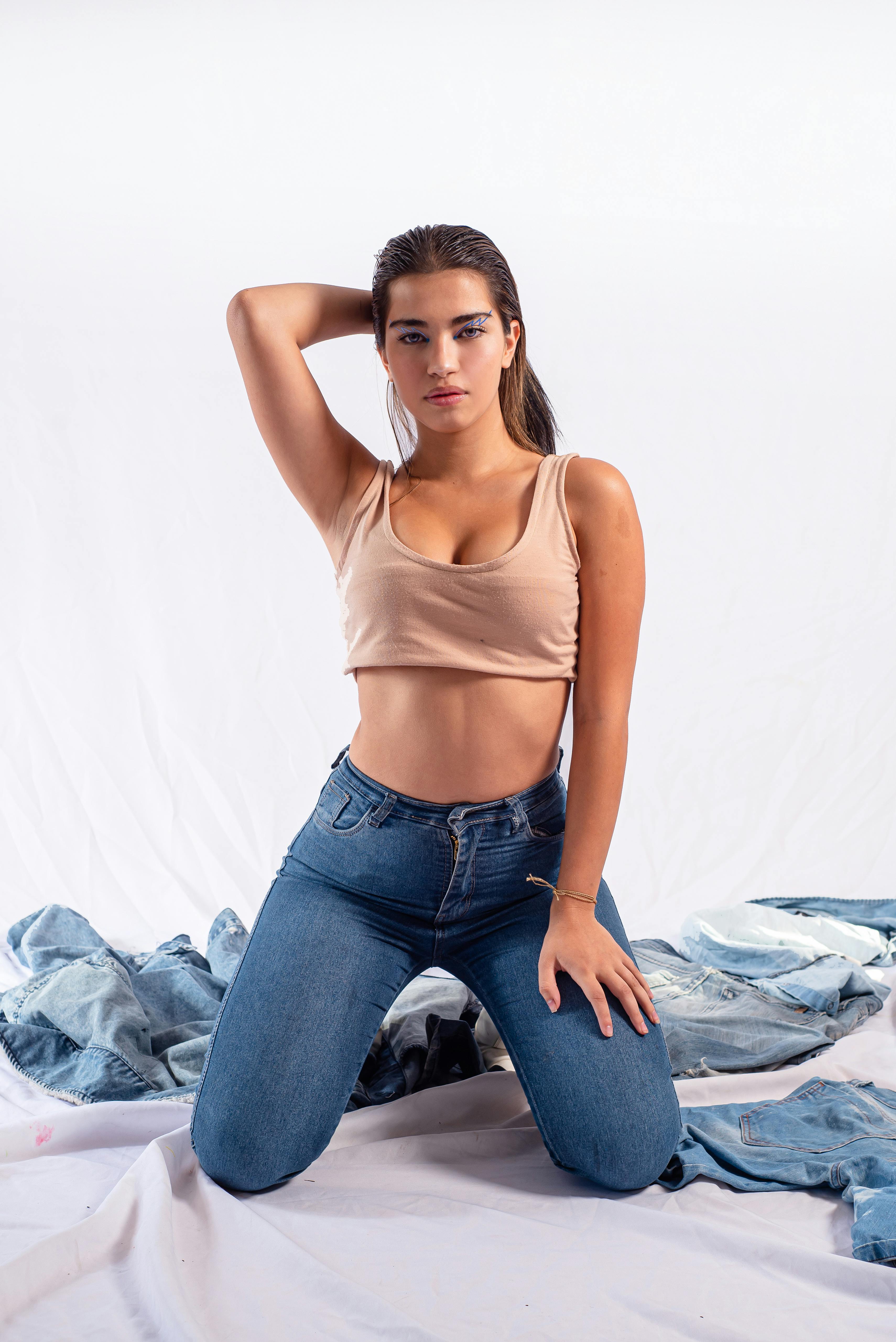 woman in jeans kneeling on ground