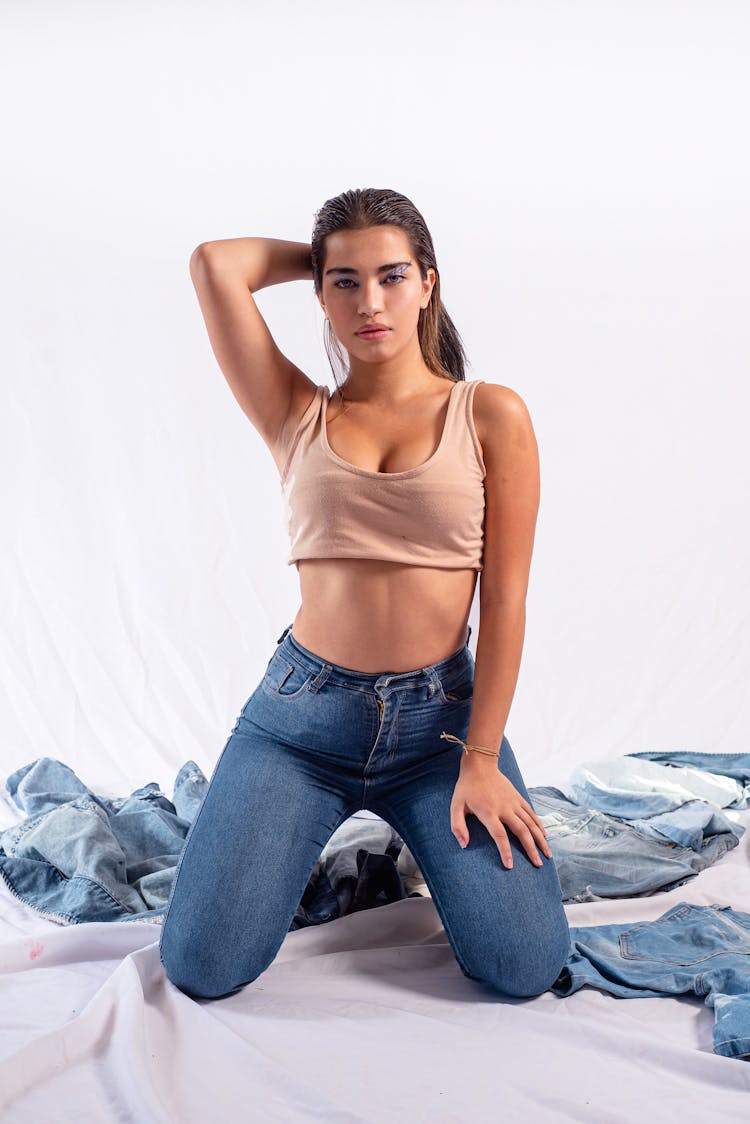 Woman In Jeans Kneeling On Ground