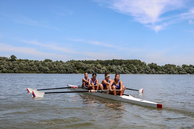 Women Rowing On River