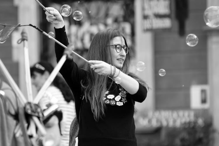 Woman Blowing Bubbles At Event