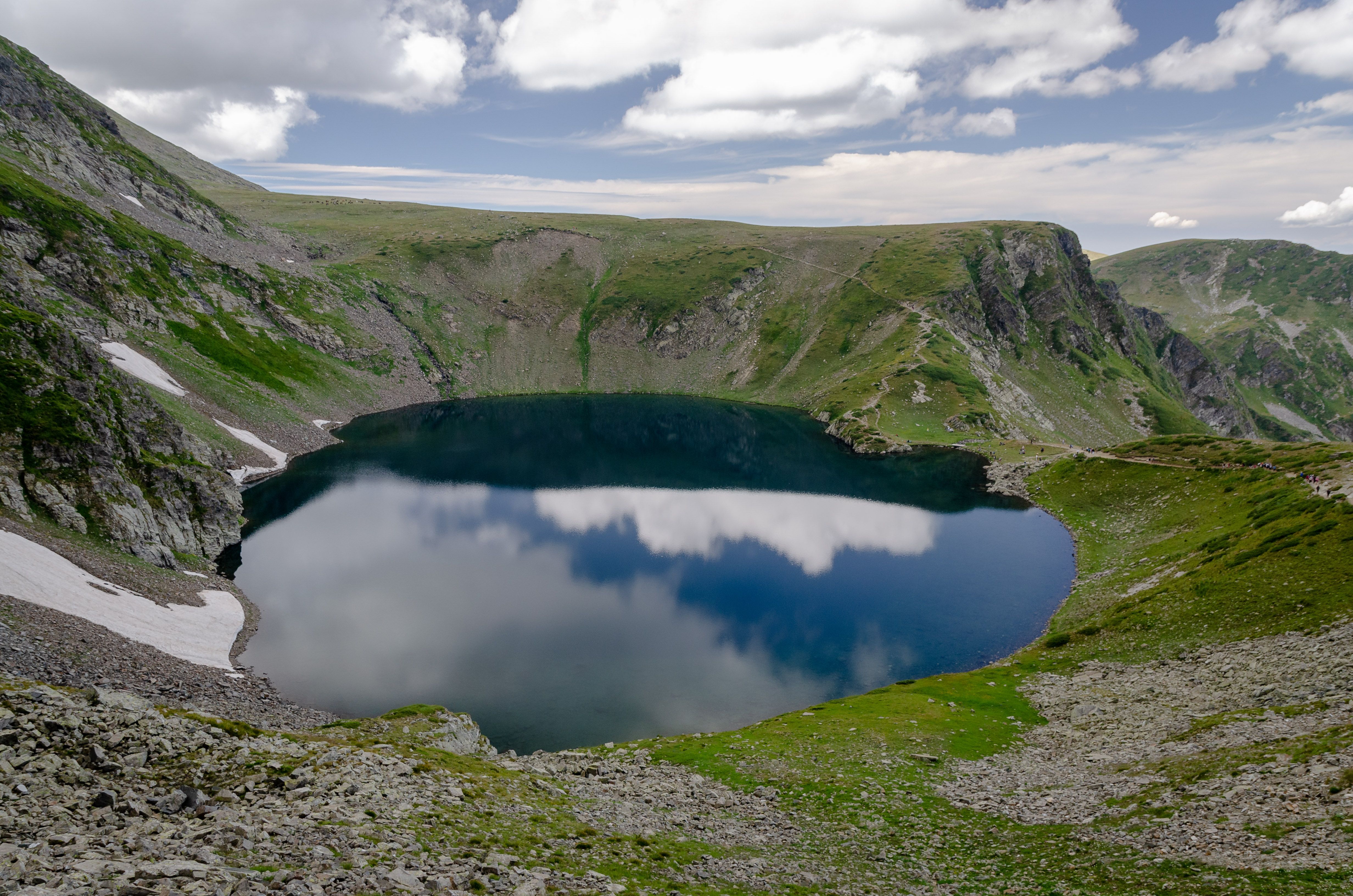 Hikers enjoying the panoramic view of the Seven Rila Lakes in Bulgaria