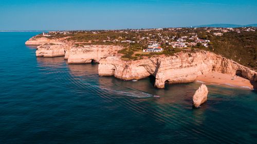 Free Aerial view of Algarve's rugged cliffs and turquoise seas, showcasing natural beauty in Portugal. Stock Photo