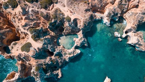 Free Stunning aerial image of a rocky coastline with clear turquoise waters. Stock Photo