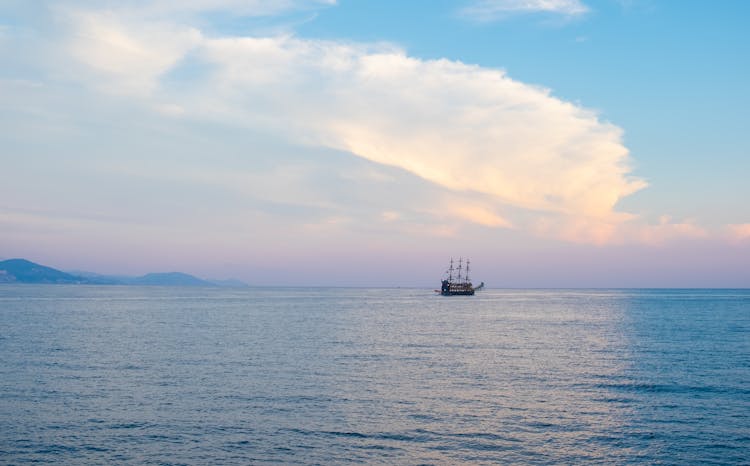 Vintage Ship Sailing Under Cloud