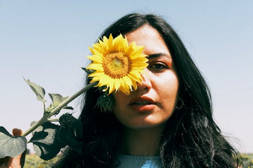 Woman Holding Sunflower over Face