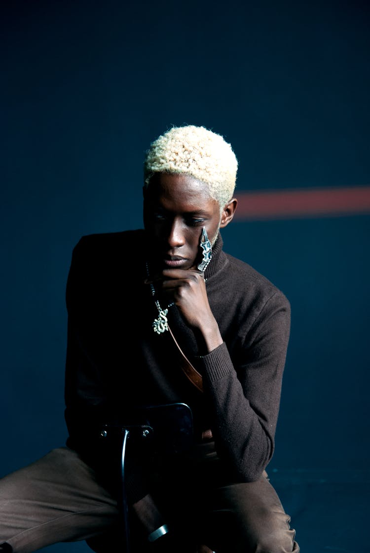 Man In White Dyed Hair Sitting