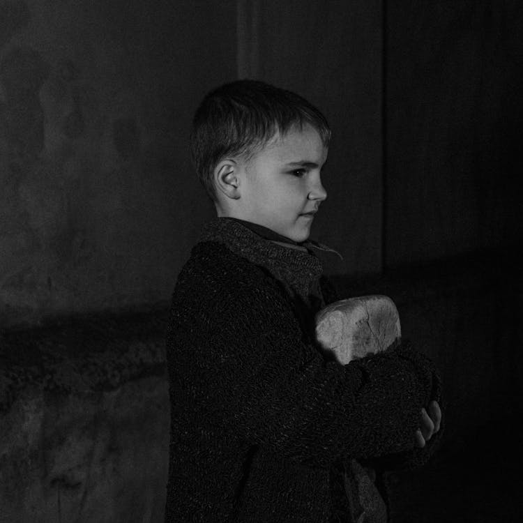 Boy Holding Bread On Arms