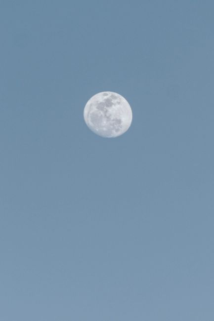 Captivating view of a full moon against a clear blue sky captured in Aracati, Brazil.