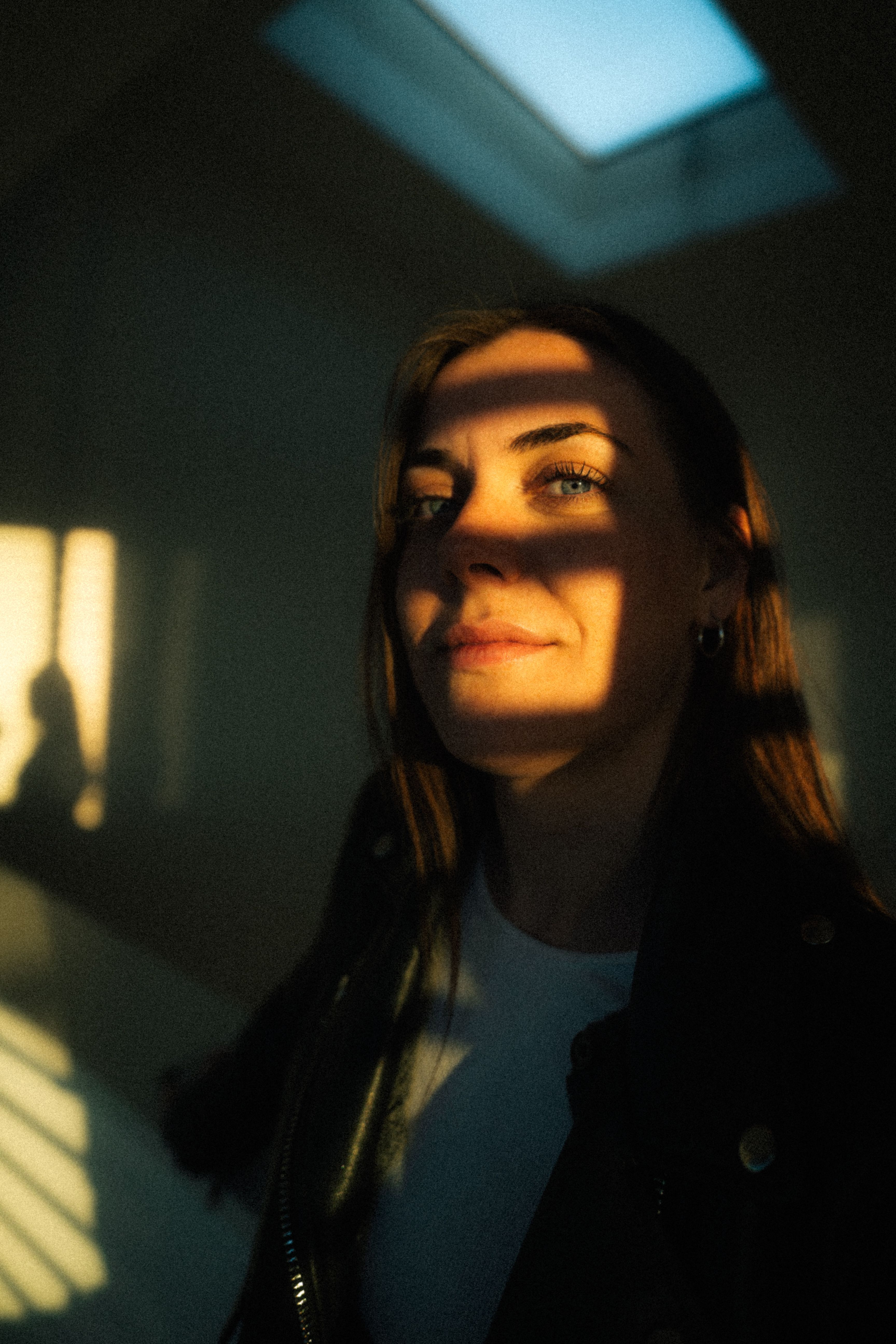 Portrait of a woman in dramatic shadows with sunlit highlights, Stuttgart.