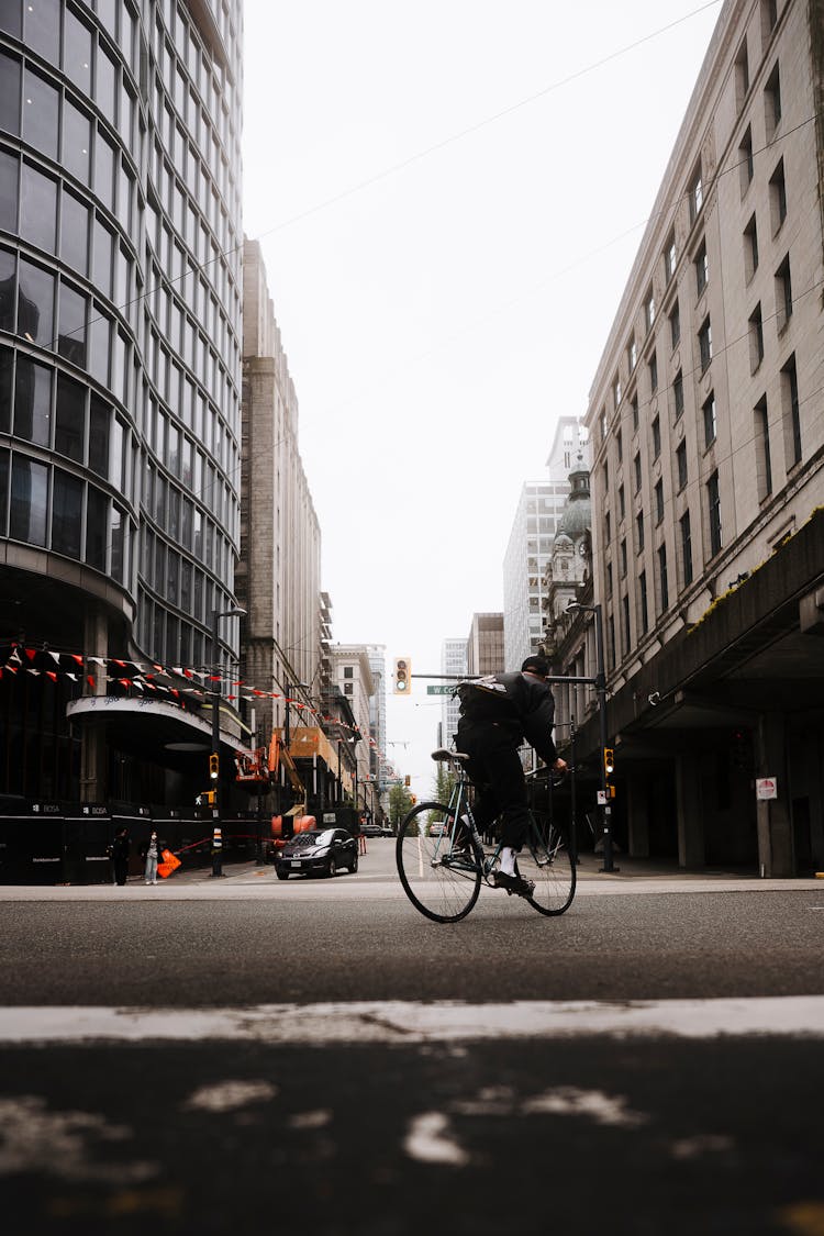 Man Riding Bike On Street